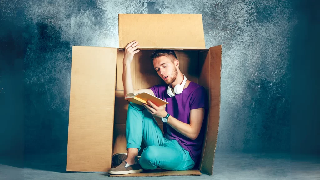 man in cardboard box